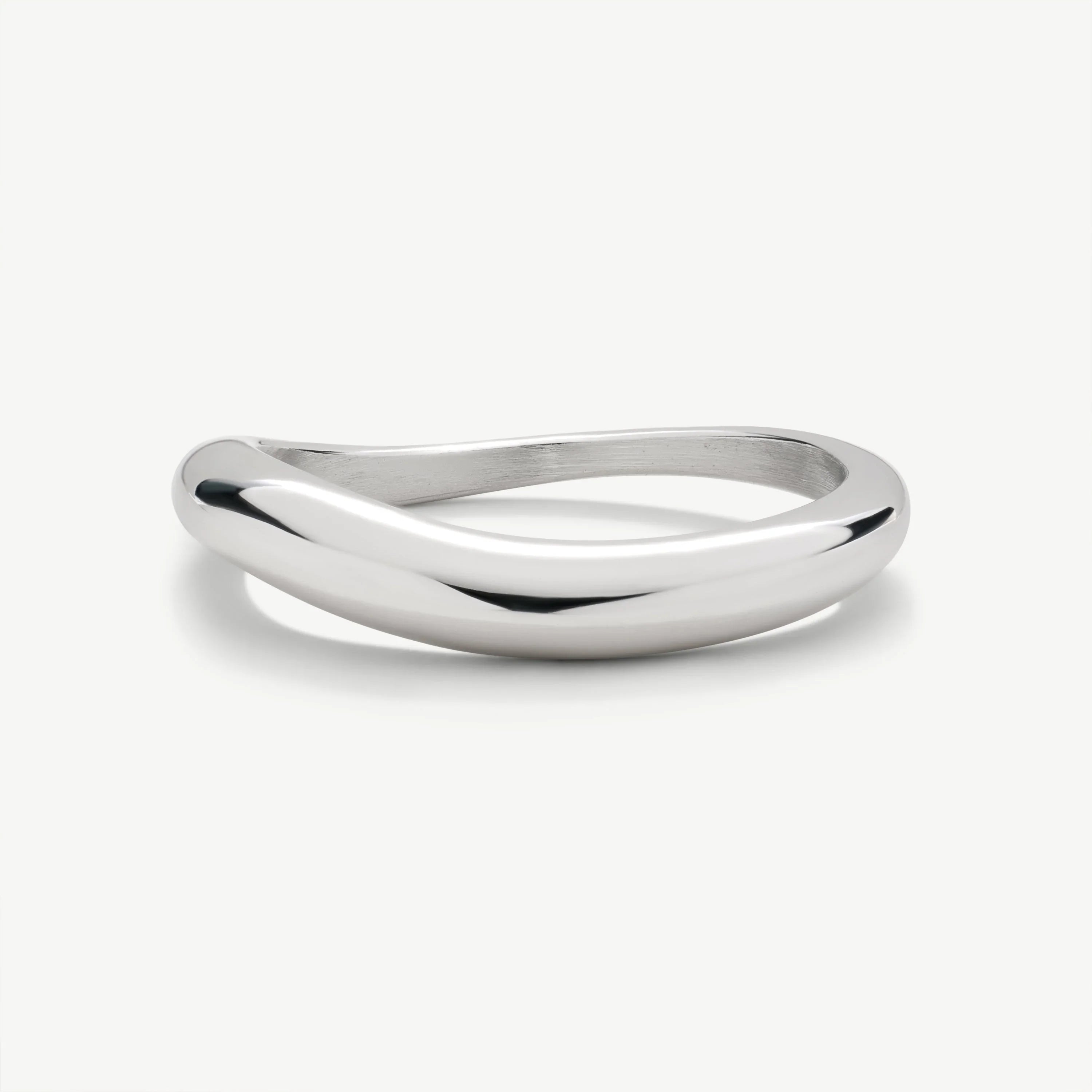Modern polished silver twisted bangle bracelet on a white background