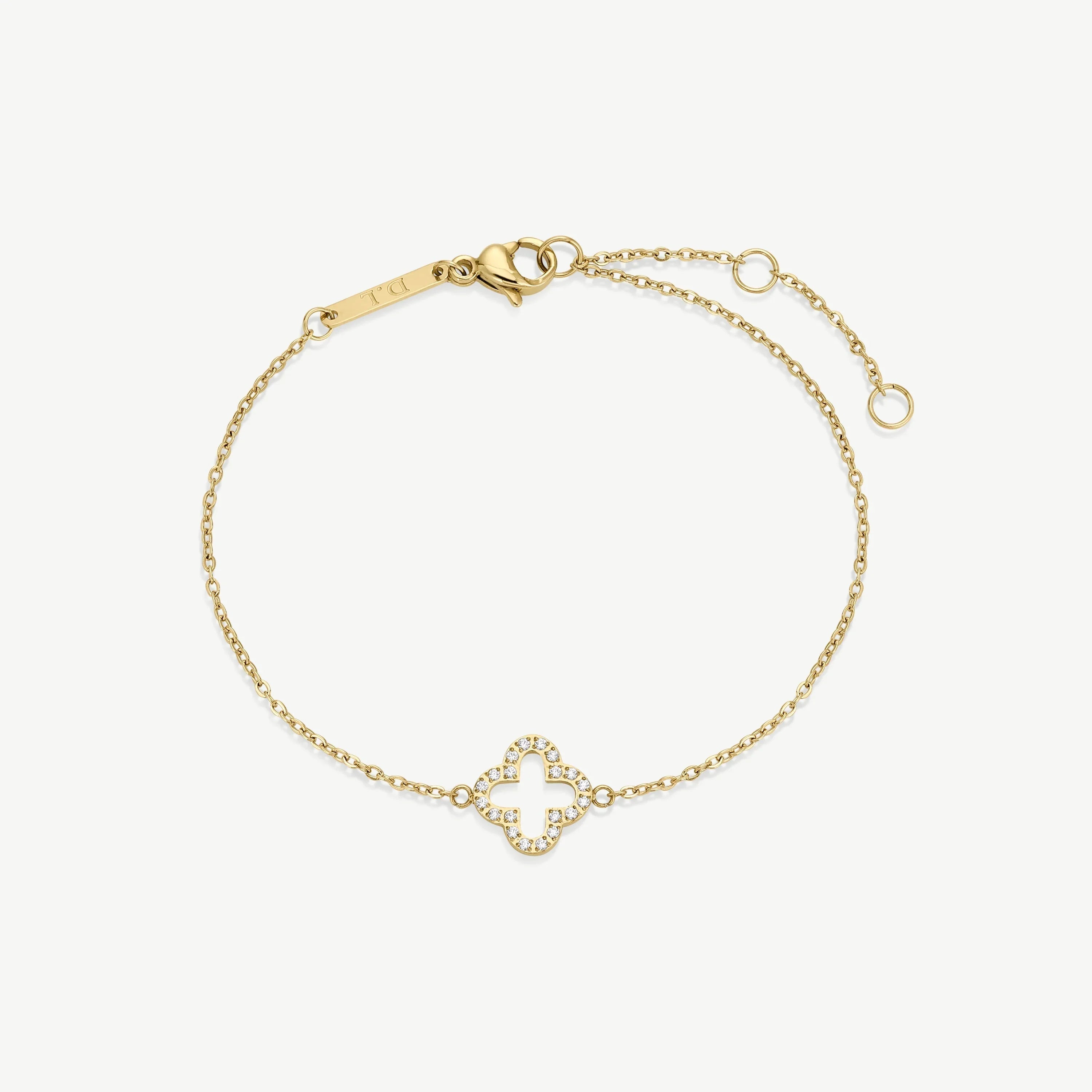 Delicate gold bracelet with clover-shaped diamond charm and adjustable chain clasp