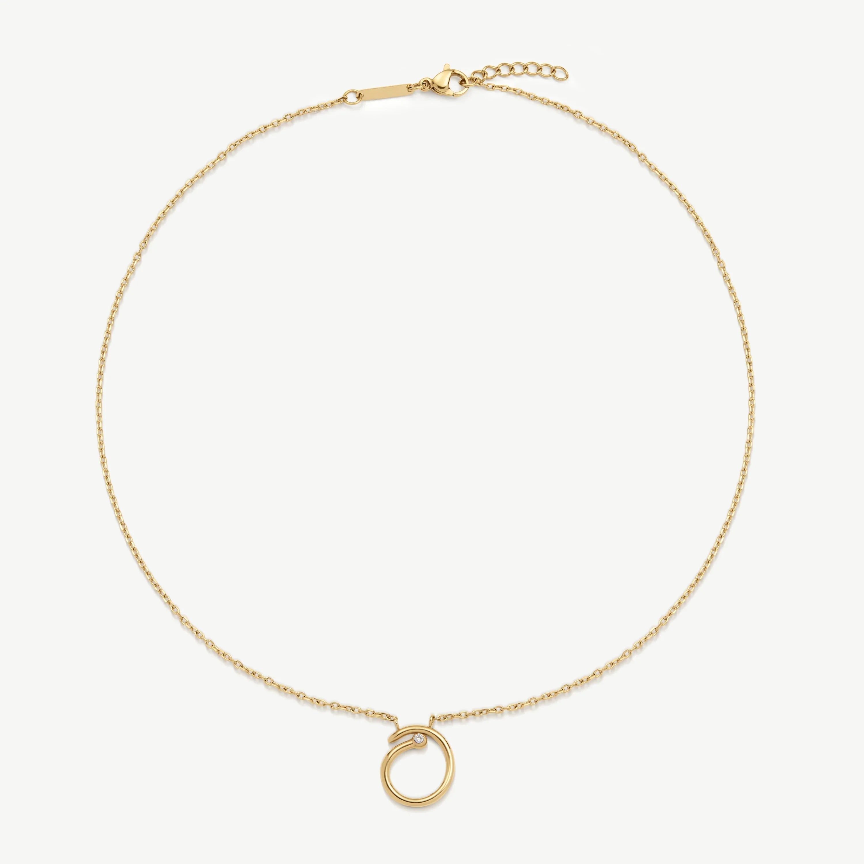 Delicate gold chain necklace with circular pendant featuring small gemstone detail
