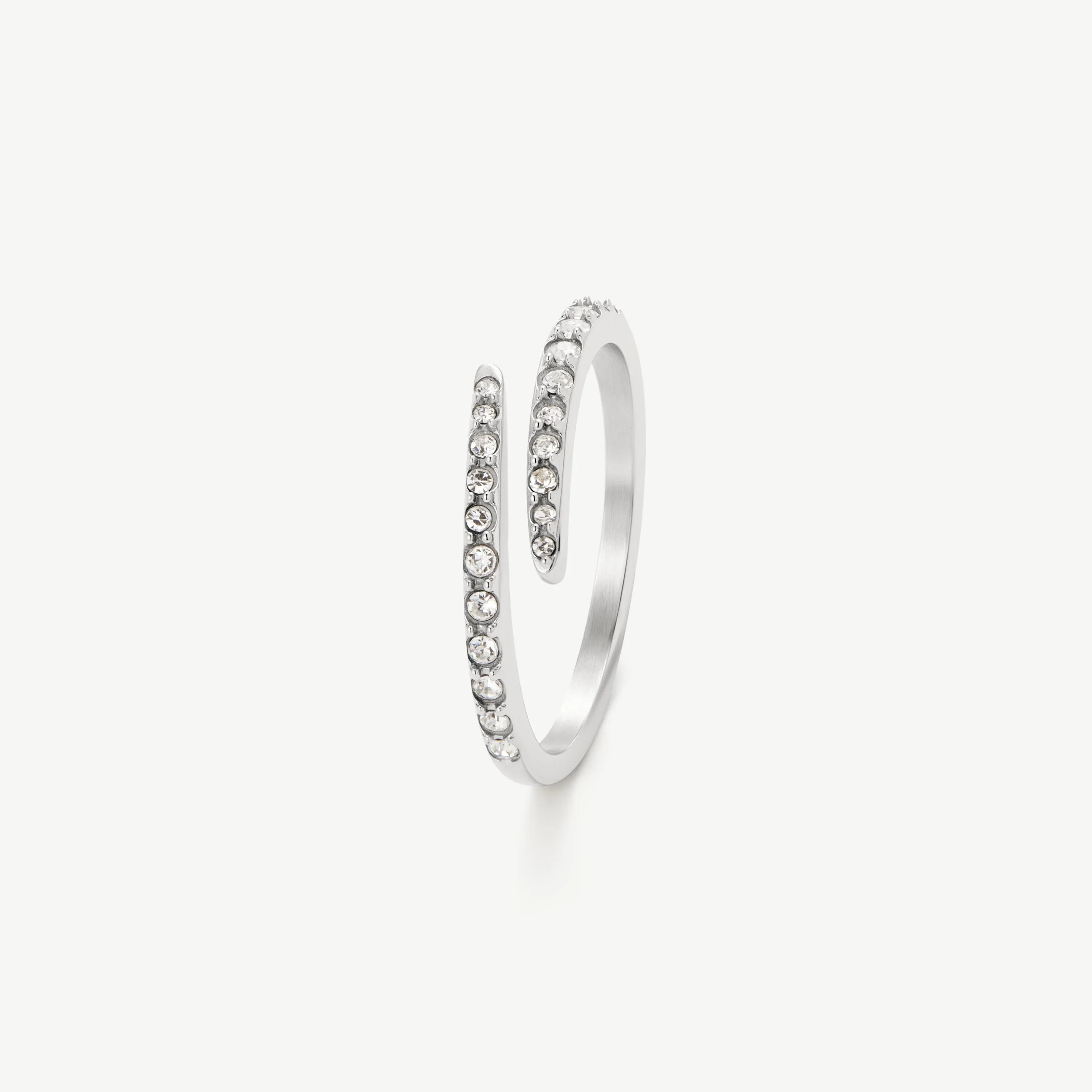 Silver open spiral ring with small clear crystals on a white background