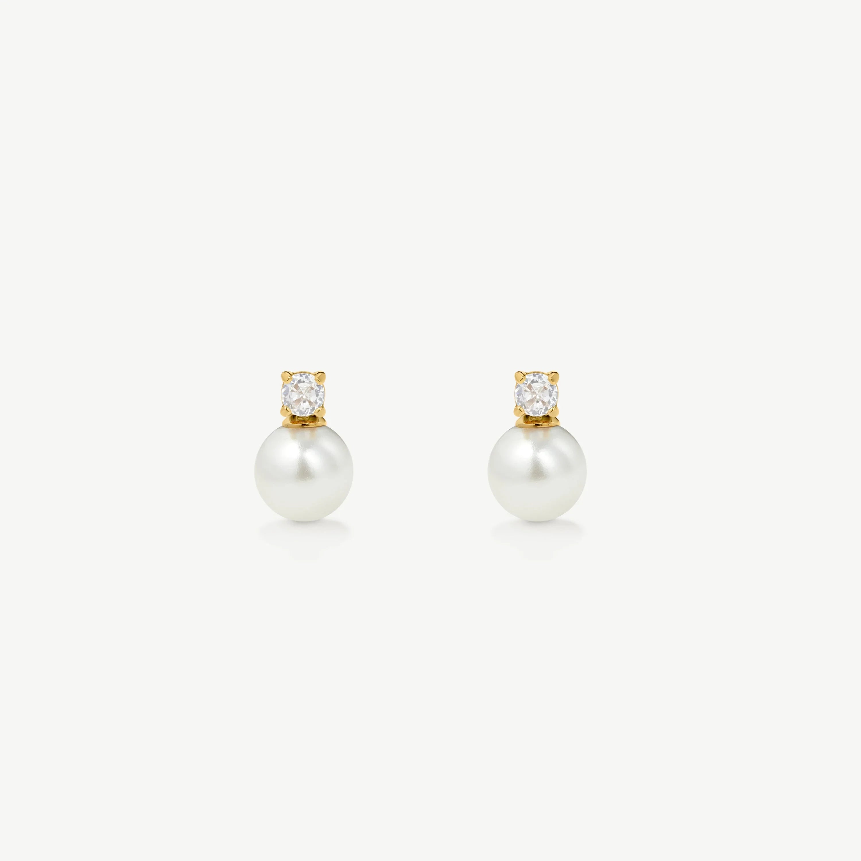Pair of elegant gold stud earrings with white pearls and clear crystal accents